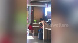 Kind grandmother feeds two kids she saw begging for change at fastfood restaurant in the Philippines