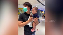 Baby boy adorably tries to lick daddy's chocolate ice cream cone