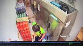 Shop worker sheepishly runs away after boxes of fizzy drinks topple over