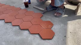 Worker builds oddly-satisfying pattern using ceramic tiles in Thailand