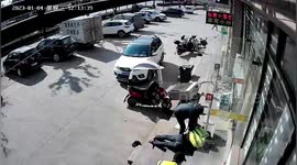 Tyre knocks police officer over after falling off truck in China