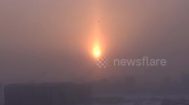 Cold winter sunset leaves sun looking like candle in clouds in St Petersburg, Russia