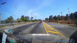 Quick-thinking drivers dodge car that spun out-of-control car along slippery highway in Thailand