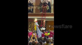Christmas presents are delivered up ladders in this Spanish city