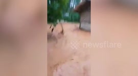 Muddy flash floods triggered by monsoon rains sweep through homes in the Philippines