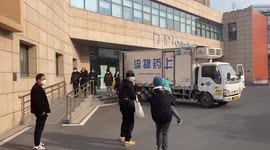 Parents take children to a community hospital in Shanghai, amid Covid-19 wave