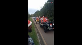 Curitiba, Brazil: Santas in jeep team up with Santas on sleigh to make kids happy