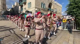Palestinians hold parade in Bethlehem with decorated trees to celebrate Orthodox Christmas