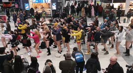 Bare-legged revellers dance the Macarena at Liverpool Street station for No Trousers Tube Ride