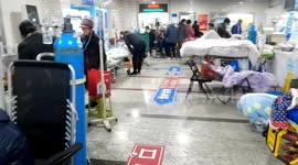 Patients awaiting treatment lie in corridors as hospital struggles with China's rising COVID-19 infections
