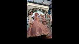 Cat strolls underneath bride's gown during wedding expo in Indonesia