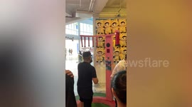 Nimble boyfriend with fast hands catches falling sticks at arcade game