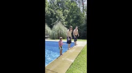 Three generations of a family perform impressive back flips into pool