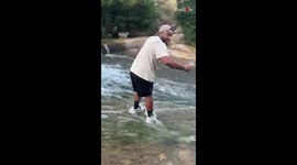 Man hilariously falls into water while trying to save his phone