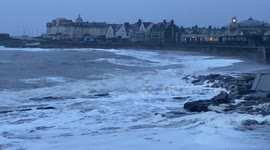 Waves crash into Porthcawl lighthouse as Met Office issues weather warning