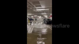 Water bursts through parking lot floor as flooding hits California