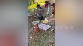 Inexperienced camper hilariously burns french fries while cooking outdoors for family
