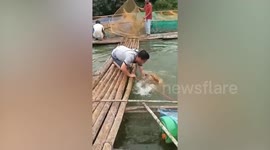 Clumsy pet owner slips off raft while pulling dog from river in Thailand