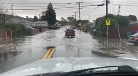 Cars passing through flooded street in Richmond, CA, USA