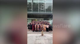 Cute stray dog photobombs graduation picture in Thailand