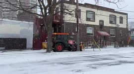 Sidewalk Plows are Plowing snow on sidewalks during a windy snow storm in East York, Toronto.