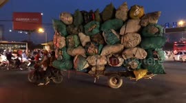 Couple carries impressive amount of rubbish on moped in Vietnam