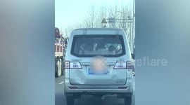 Girl spotted swinging at back seat of minibus on Chinese road