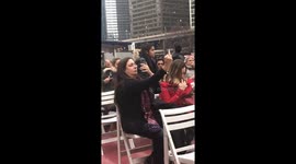 Woman takes picture of her middle finger facing Trump Tower in New York, US