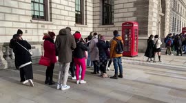 Tourists form huge queues to take photos with an iconic red telephone box