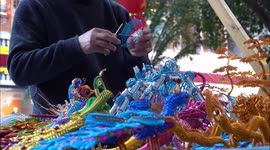 A Folk Artist Weaves Crafts At A Temple Fair In Yichang, China