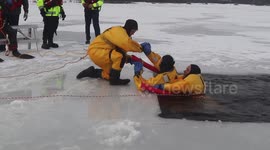 Firefighters train for ice rescue scenarios 15 feet under frozen lake in Wisconsin, US