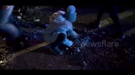 Ukrainian girl clears rubble after Russian strike on residential building in Dnipro