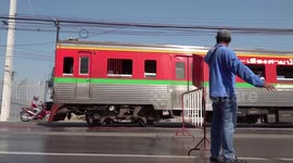 Train appears to glide along road surface at bizarre level cross in Thailand