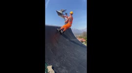 Guy with wheelbarrow and rollerblades does tricks on skate ramp