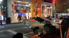 Shibuya lowrider bounces down a busy street in Tokyo
