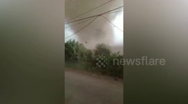 Dust devil tornado forms next to cars and damages 10 houses in Indonesia