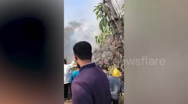 Smoke billows from burning wreckage of plane crash that killed 68 in Nepal
