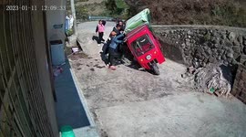 Residents lift three-wheeler up together to free rider trapped under it in China