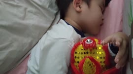 This toddler is a super fan of 'Mini Lion' , he even sleeps with it!
