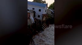 House collapses into canal amid flash floods in Cambodia