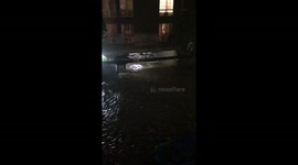 Floodwater gushes into Los Angeles underground garage