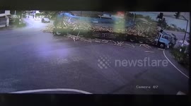 Truck crashes at junction spilling hundreds of logs onto road