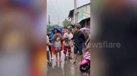 Residents rescue massive wild python along flooded drain during storm in the Philippines