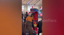 Muay Thai boxer smashes punch bag arcade game at shopping mall