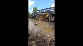 Operator expertly guides excavator on ferry through narrow bridge in Vietnam