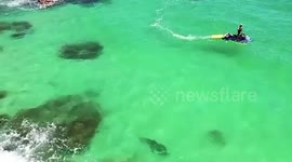 Operator uses his drone to save beachgoers from a potential shark attack at Meelup Beach in Australia