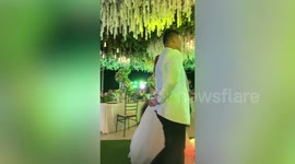 Wedding fail! Couple keep calm during first dance as flowers catch FIRE behind them