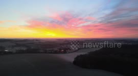 Slow rising drone shot overlooking natural sunrise in 4k