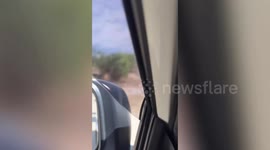 Dust devil tornado whips along dusty surface on hot day in the Philippines