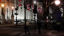 A suspicious car abandoned in Trafalgar Square causes police to cordon of the area and move on the Iraqi football team supporters cutting short their celebrations.  The car can be seen with flashing lights and police can be seen looking at and opening up
